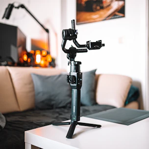 A friendly technician setting up a walker inside a bright living room.