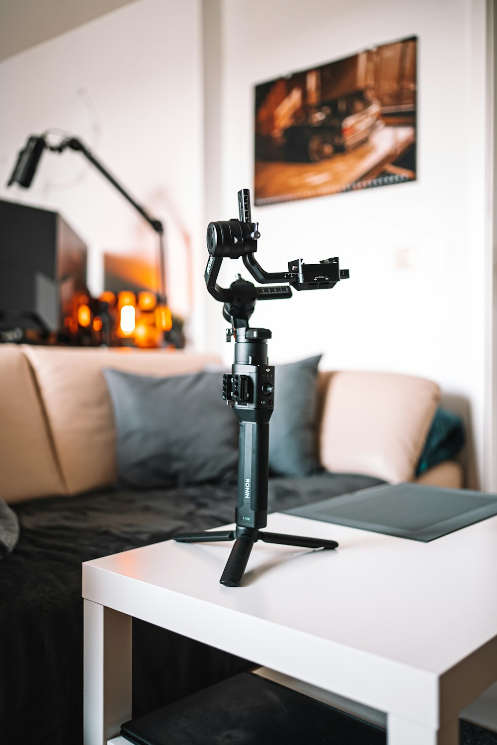 a camera tripod sitting on top of a white table