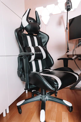 a black and white office chair sitting in a room