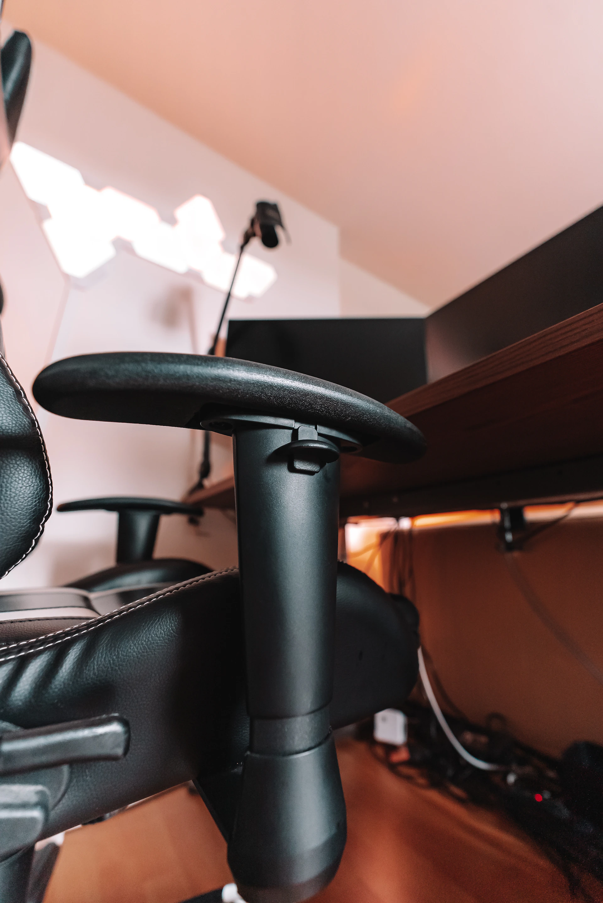 a black office chair with a black arm rest