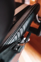 A technician carefully cleaning an office chair upholstery.