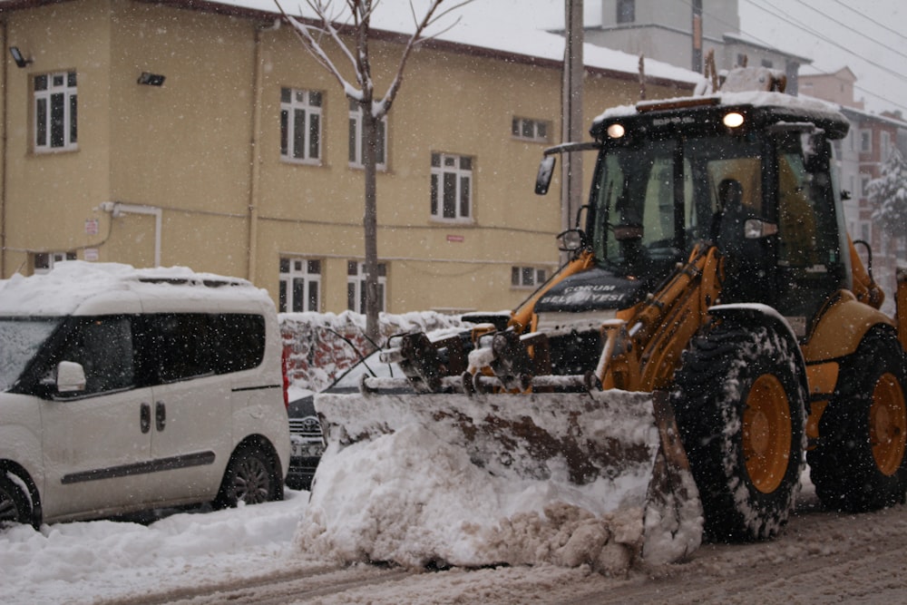 a snow plow is parked on the side of the road