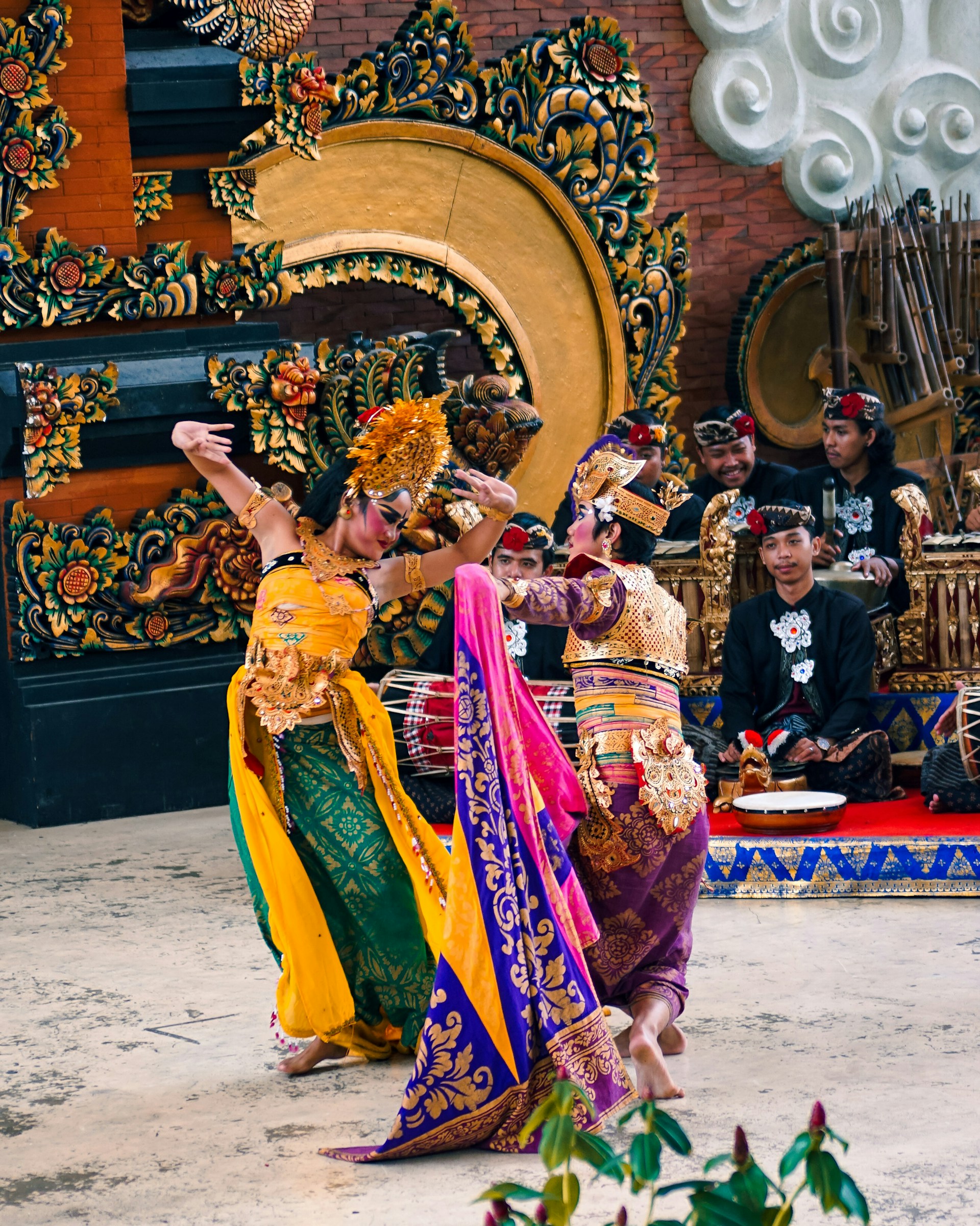 Close-up of dancers’ hands gracefully holding traditional props, highlighting intricate details of their colorful attire and cultural heritage.