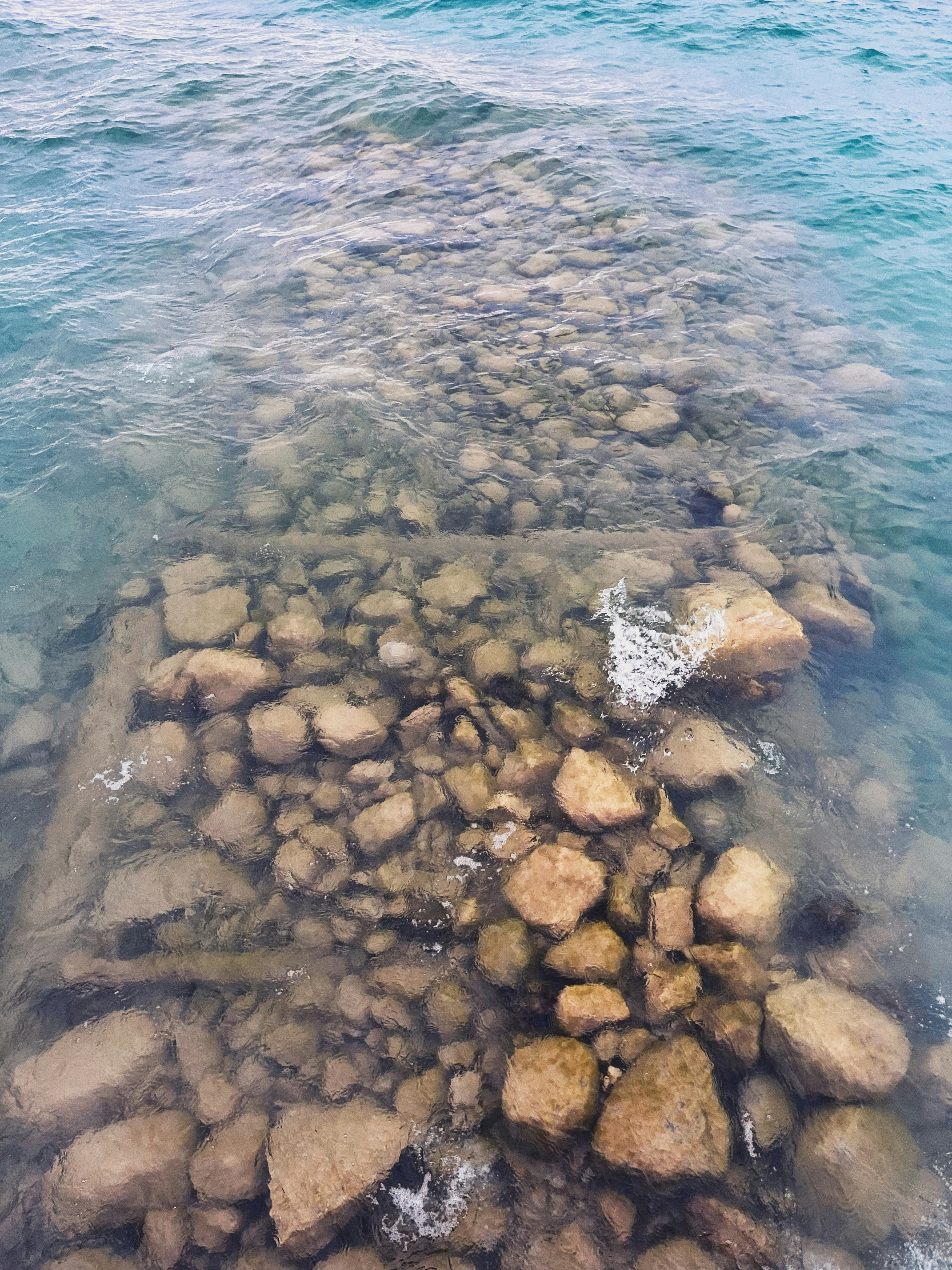 a large body of water with rocks in it