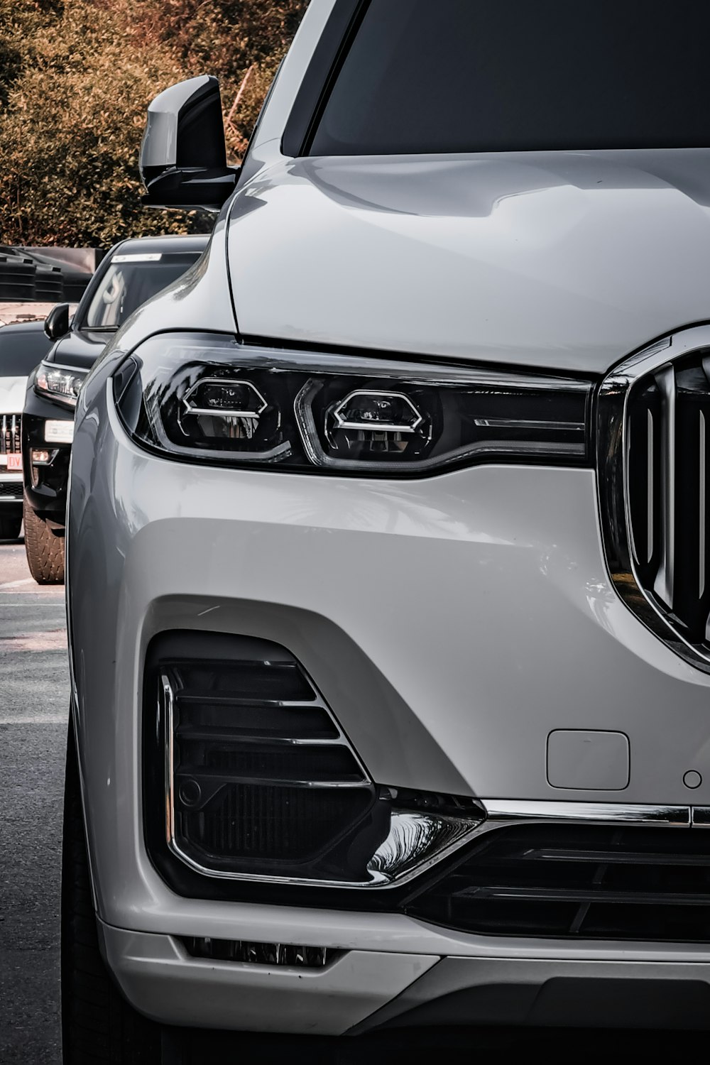 a white bmw suv parked in a parking lot