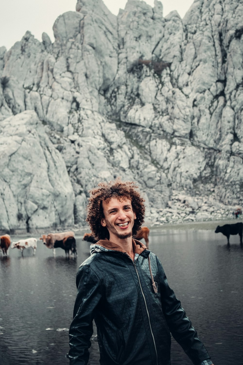 a man standing in front of a herd of cattle