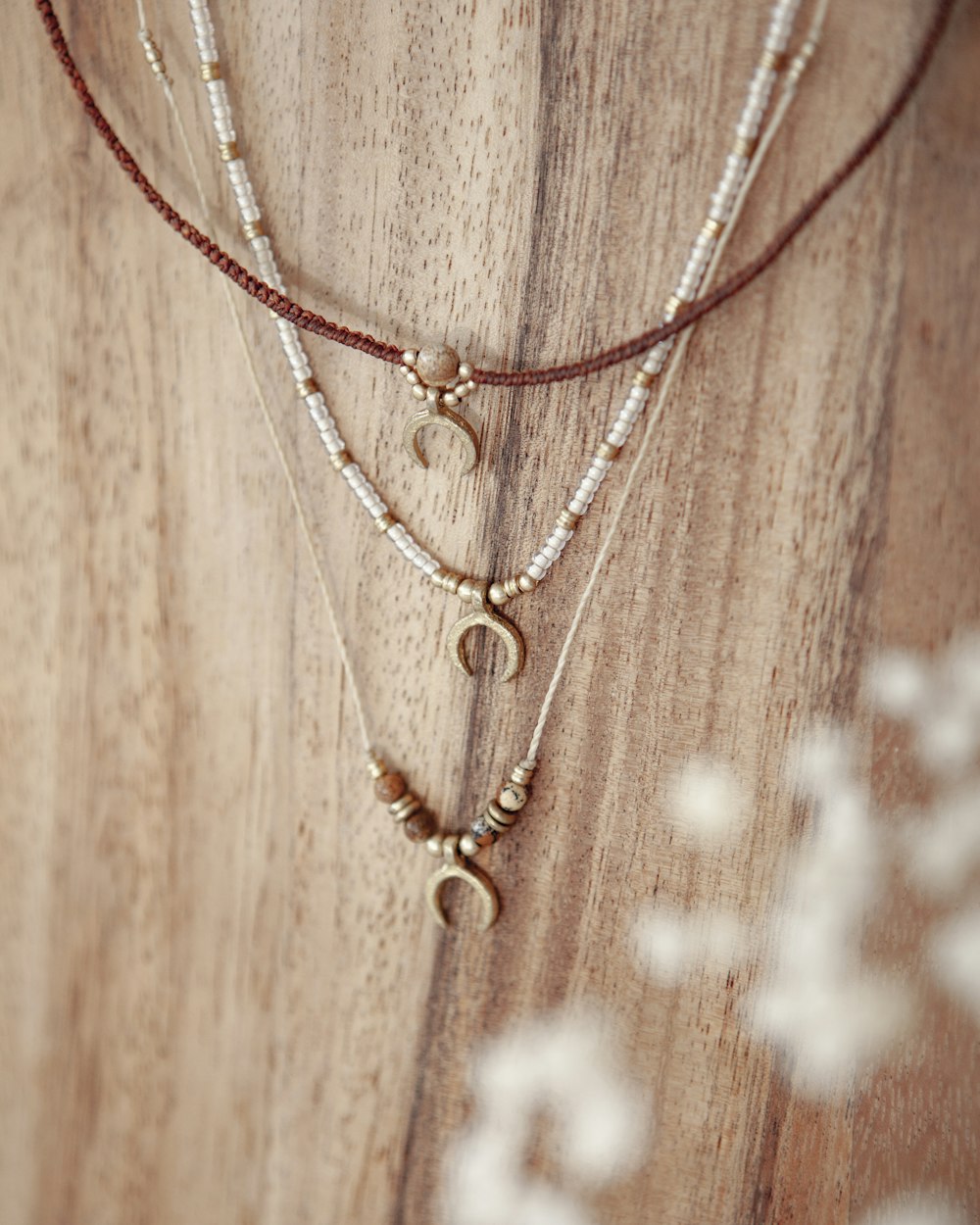 a close up of a necklace on a wooden surface