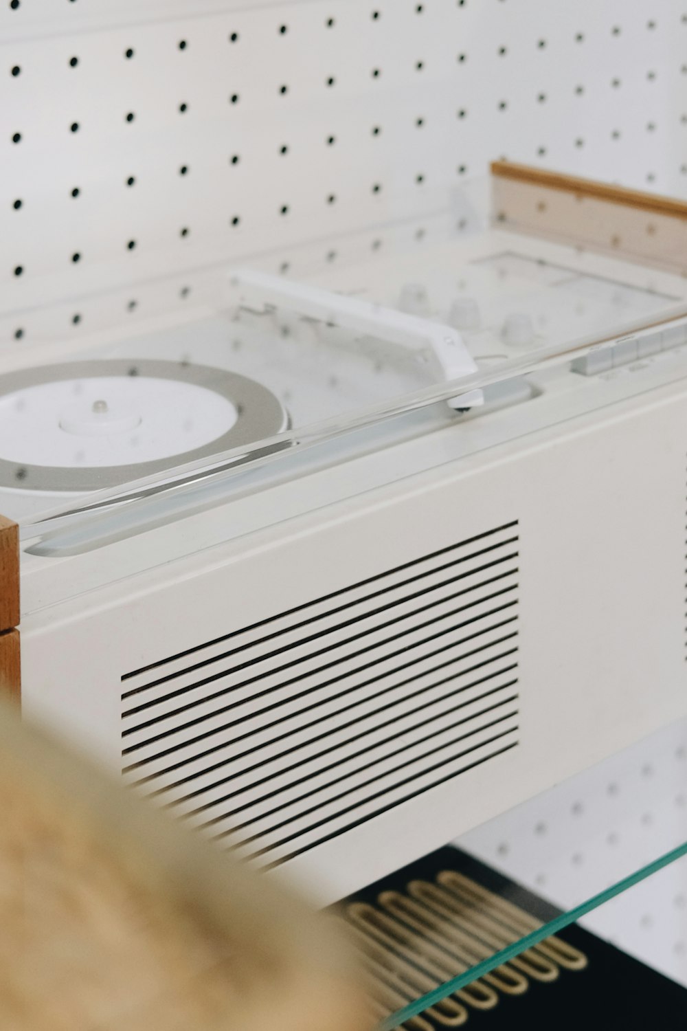 a white clock sitting on top of a shelf