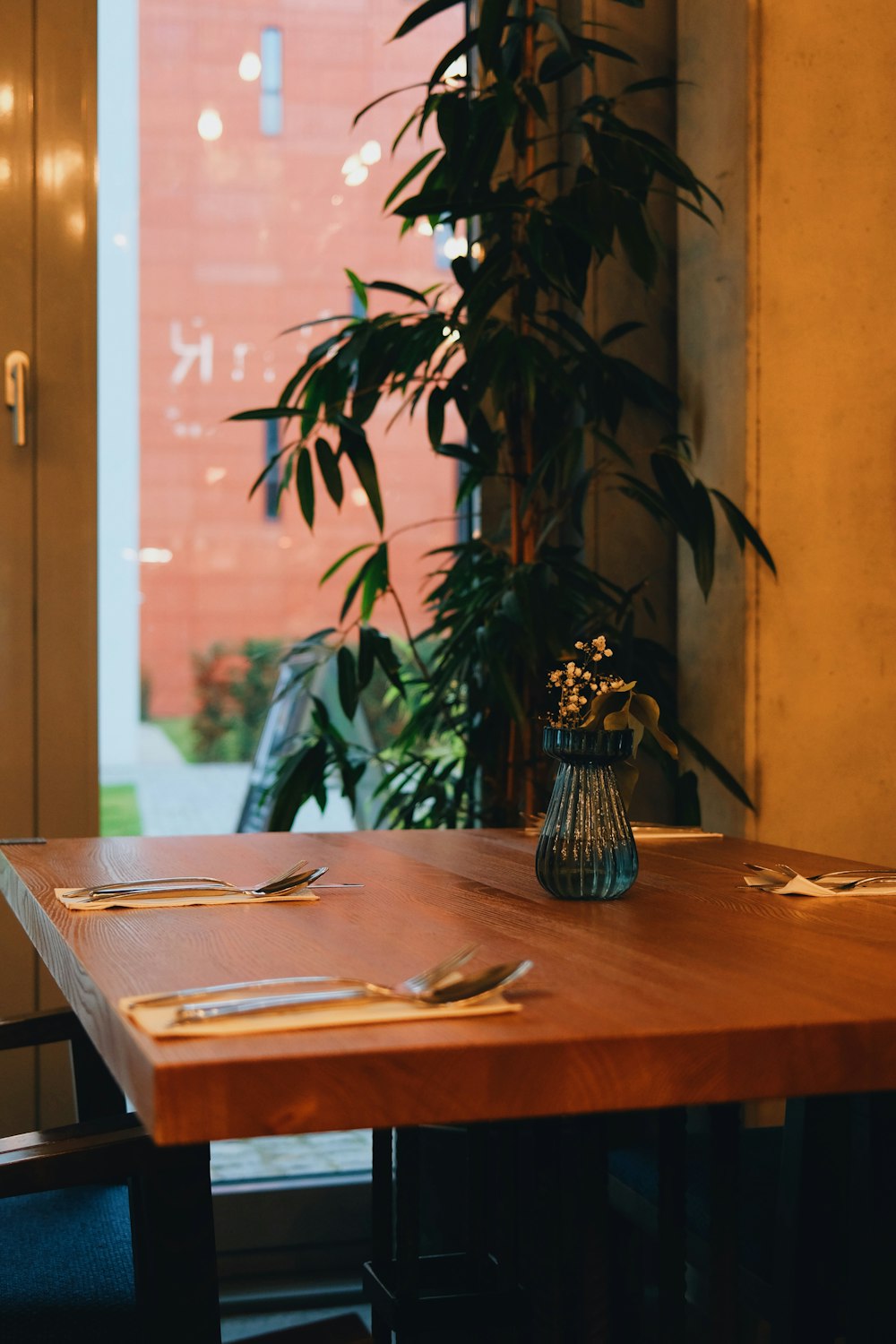 a wooden table with a vase of flowers on top of it