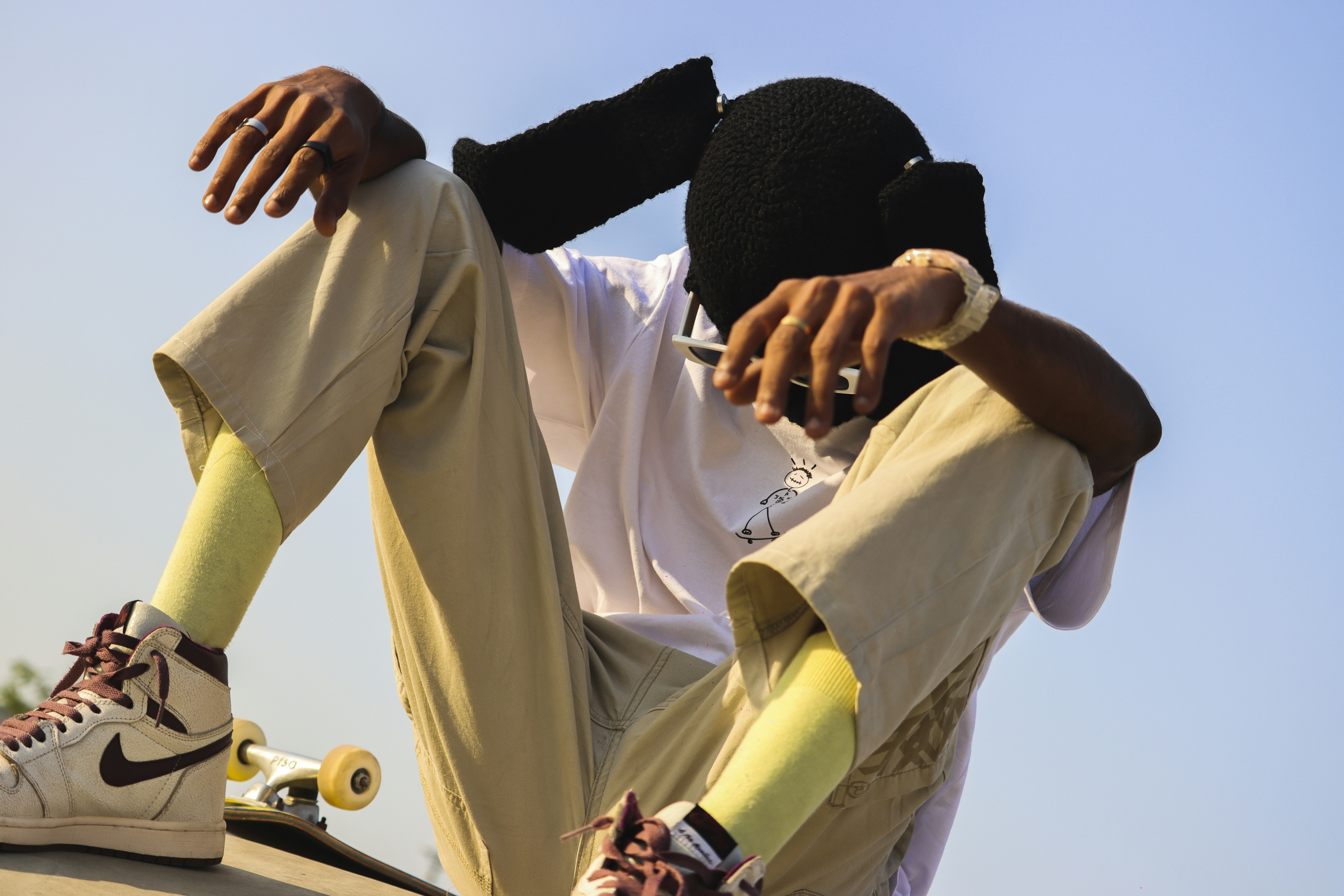 a young man sitting on top of a skateboard