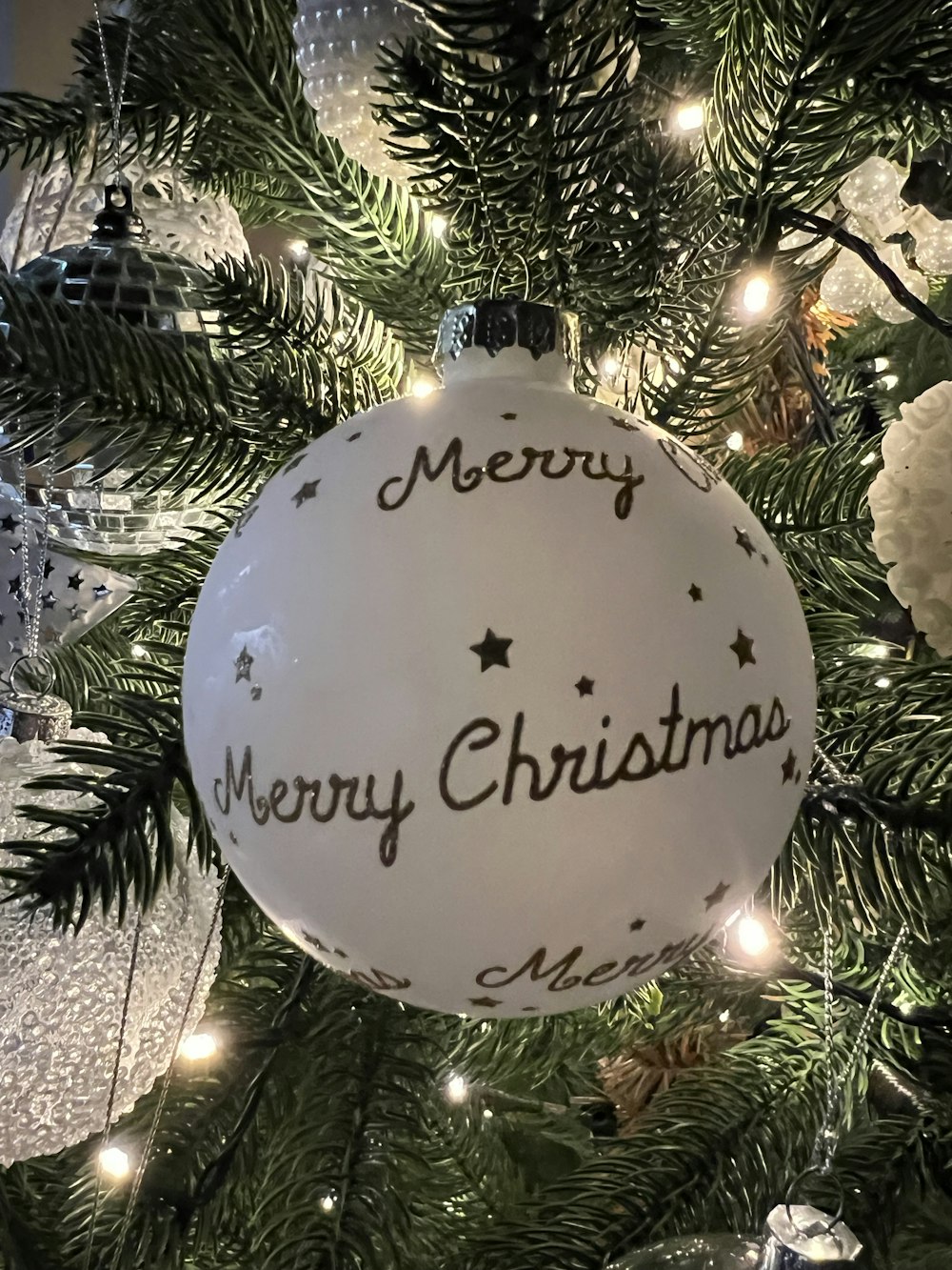 a christmas ornament hanging from a christmas tree