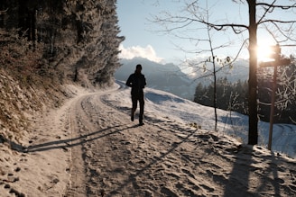 a person walking down a snow covered road