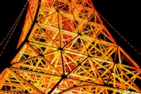 The top of the eiffel tower lit up at night