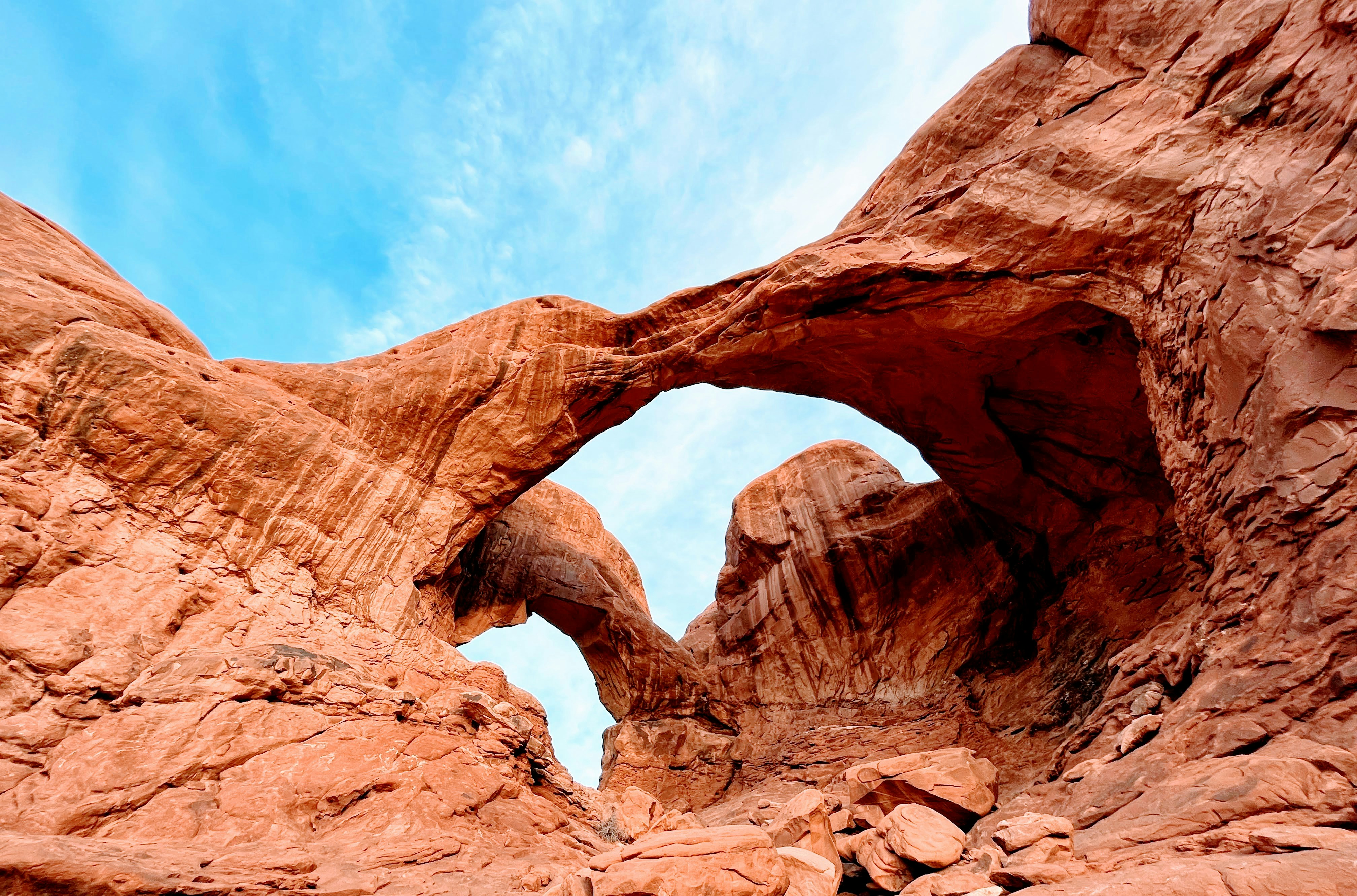 a large rock formation with a sky in the background, Double Arch @ Arches National Park, Utah