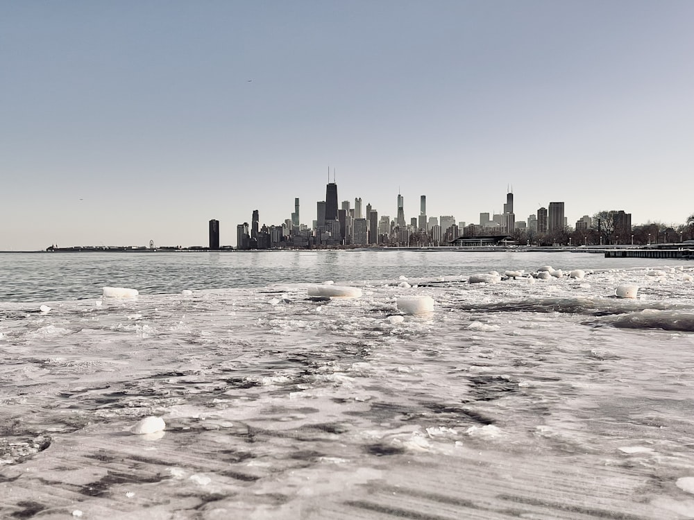 a large body of water with a city in the background