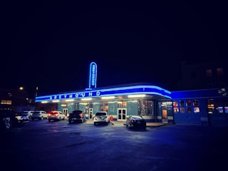 Photo of a Greyhound bus pulling up at a busy city terminal.