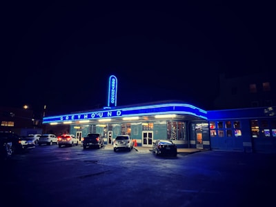 Photo of a Greyhound bus pulling up at a busy city terminal.