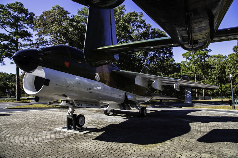 a small airplane parked on a brick road