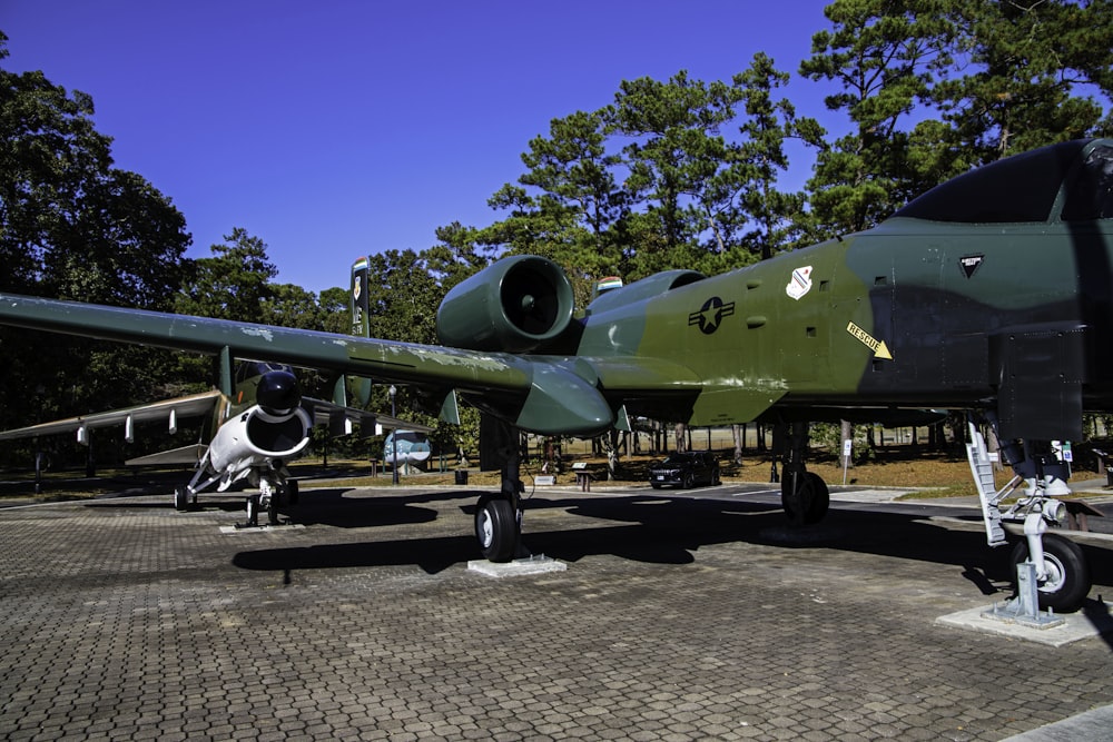 a green and black plane is on display