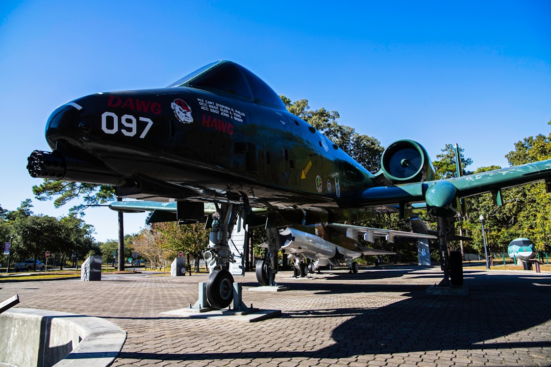 a large propeller plane sitting on top of a stone walkway,
