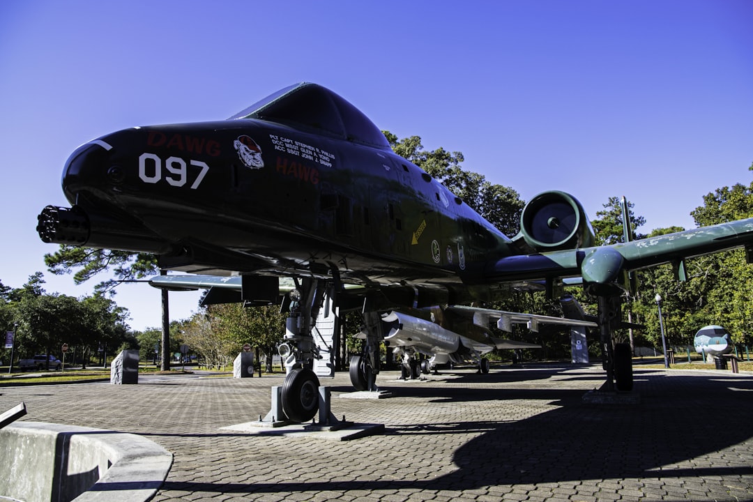 a large propeller plane sitting on top of a stone walkway,