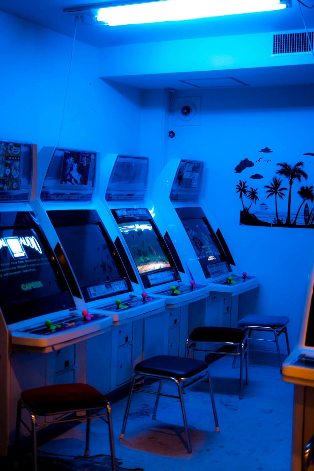 a room with a bunch of arcade machines in it