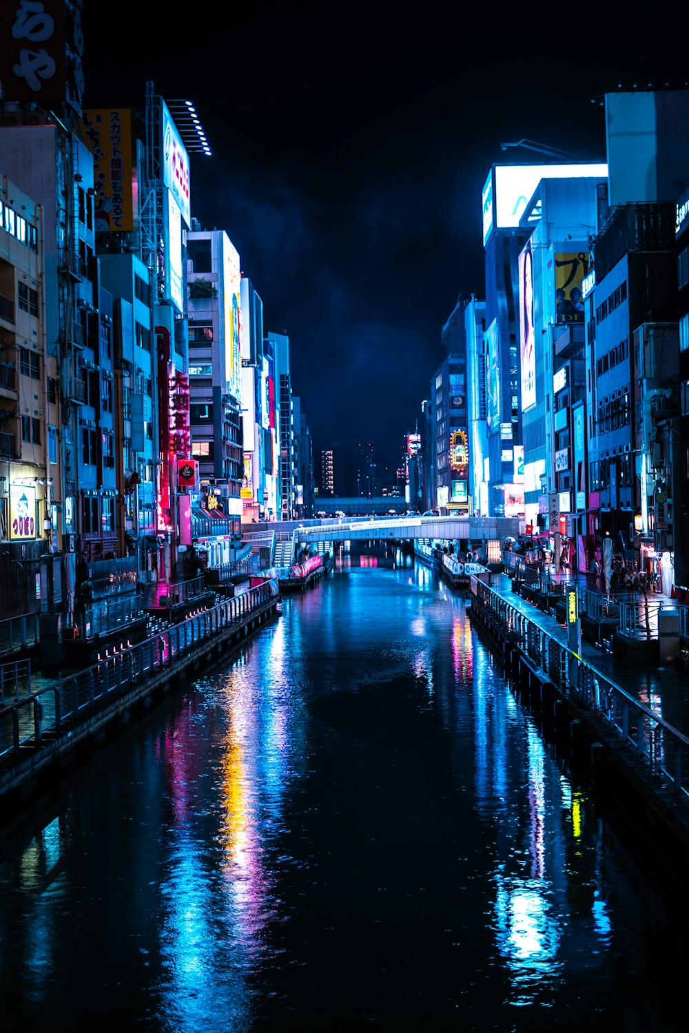 a river running through a city next to tall buildings