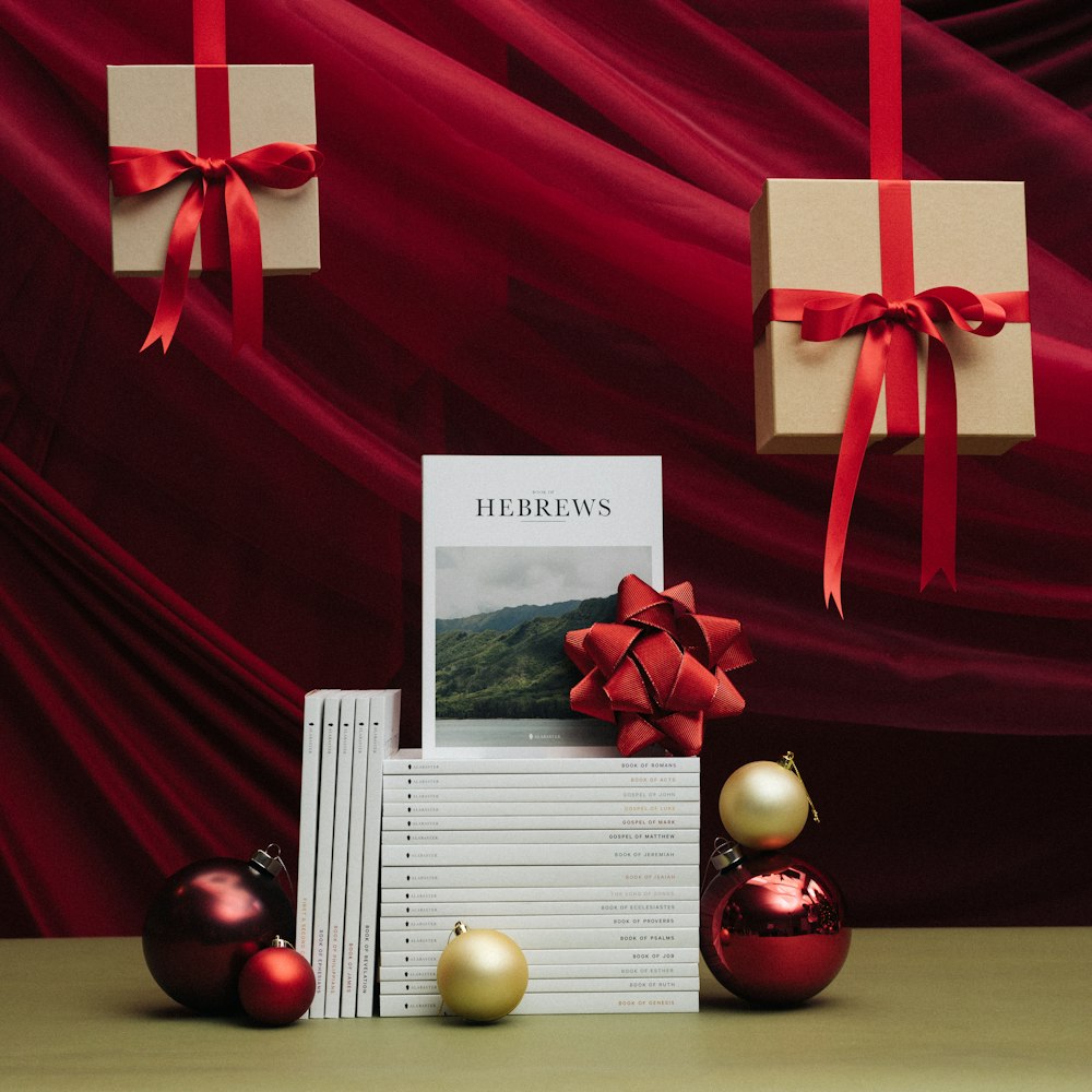 a stack of books sitting next to christmas ornaments