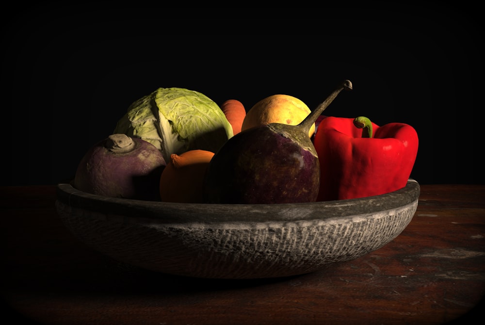 a bowl of fruit and vegetables on a table
