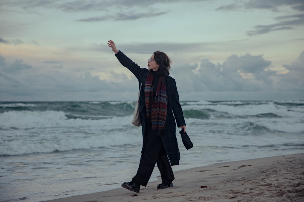 a person walking on a beach near the ocean