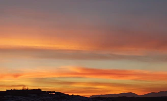 Sunset over Monterrey's Cerro de la Silla with vibrant orange and pink hues.