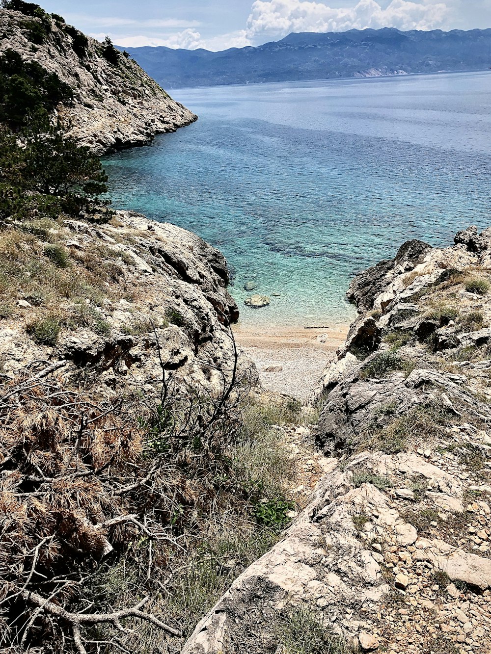 a view of a body of water from a rocky cliff