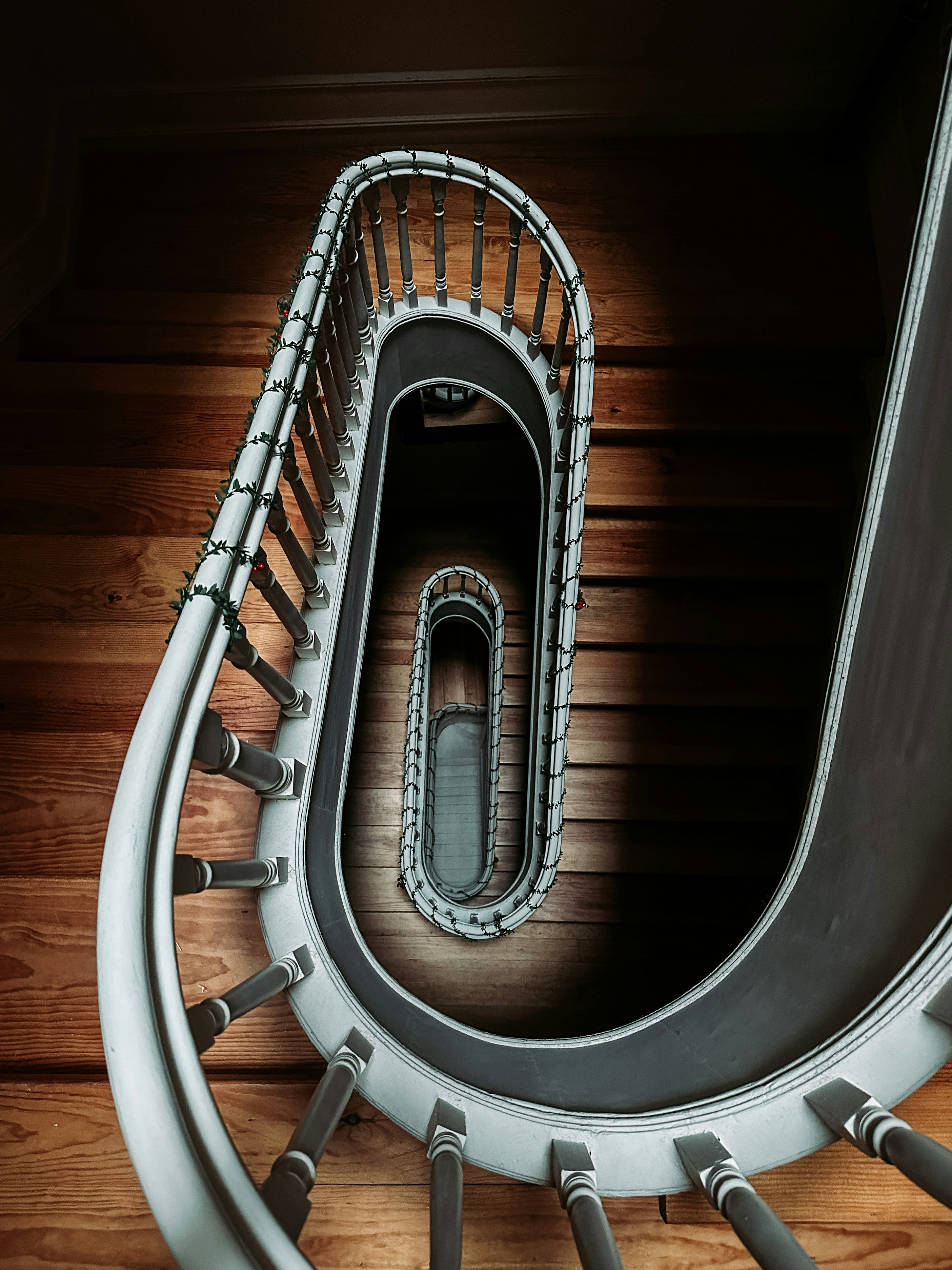a spiral staircase in a building with wood flooring