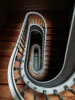 a spiral staircase in a building with wood flooring