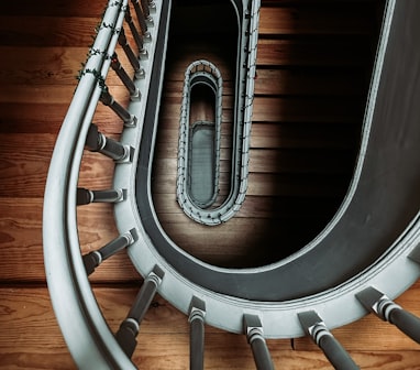 a spiral staircase in a building with wood flooring