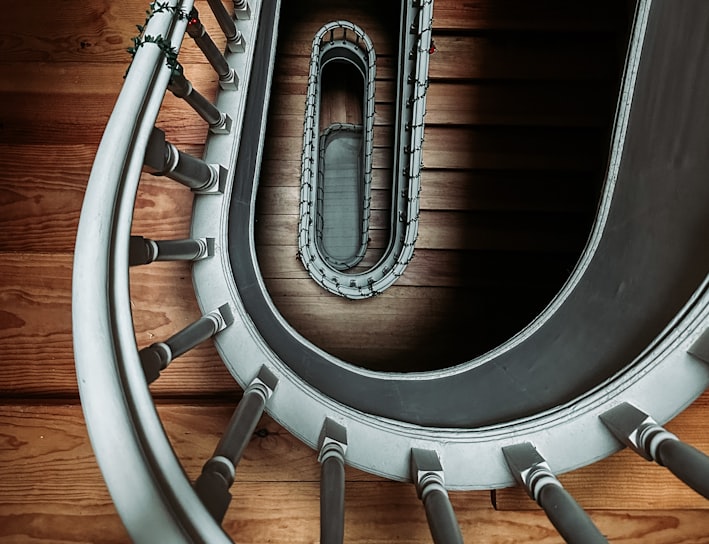 a spiral staircase in a building with wood flooring