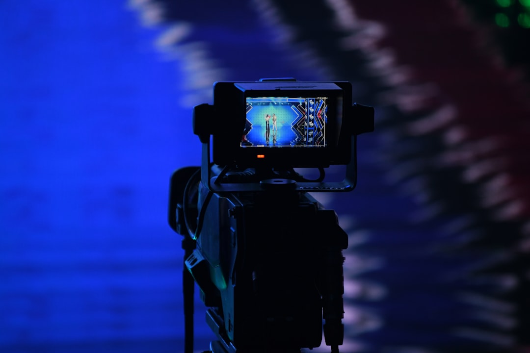 a video camera with a picture of a person on it, Camera in a TV set