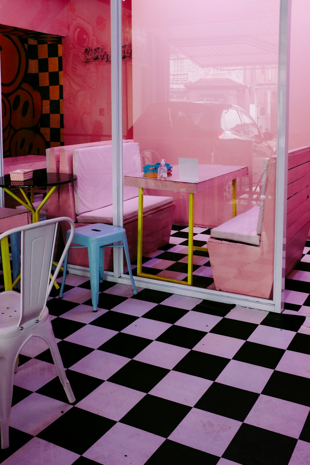 a room with a checkered floor and pink walls