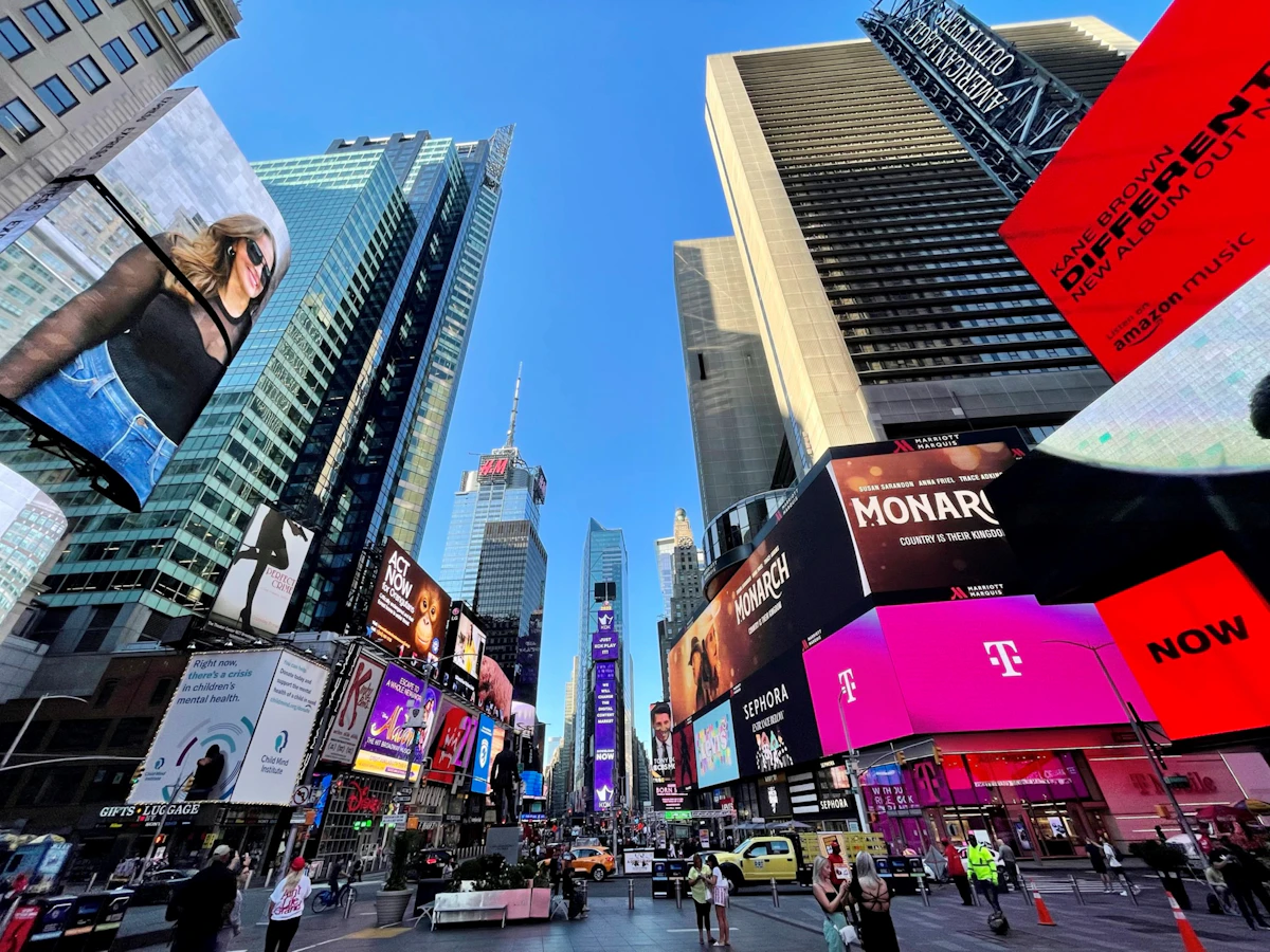 Illuminated billboards and crowds at Times Square in New York City at night