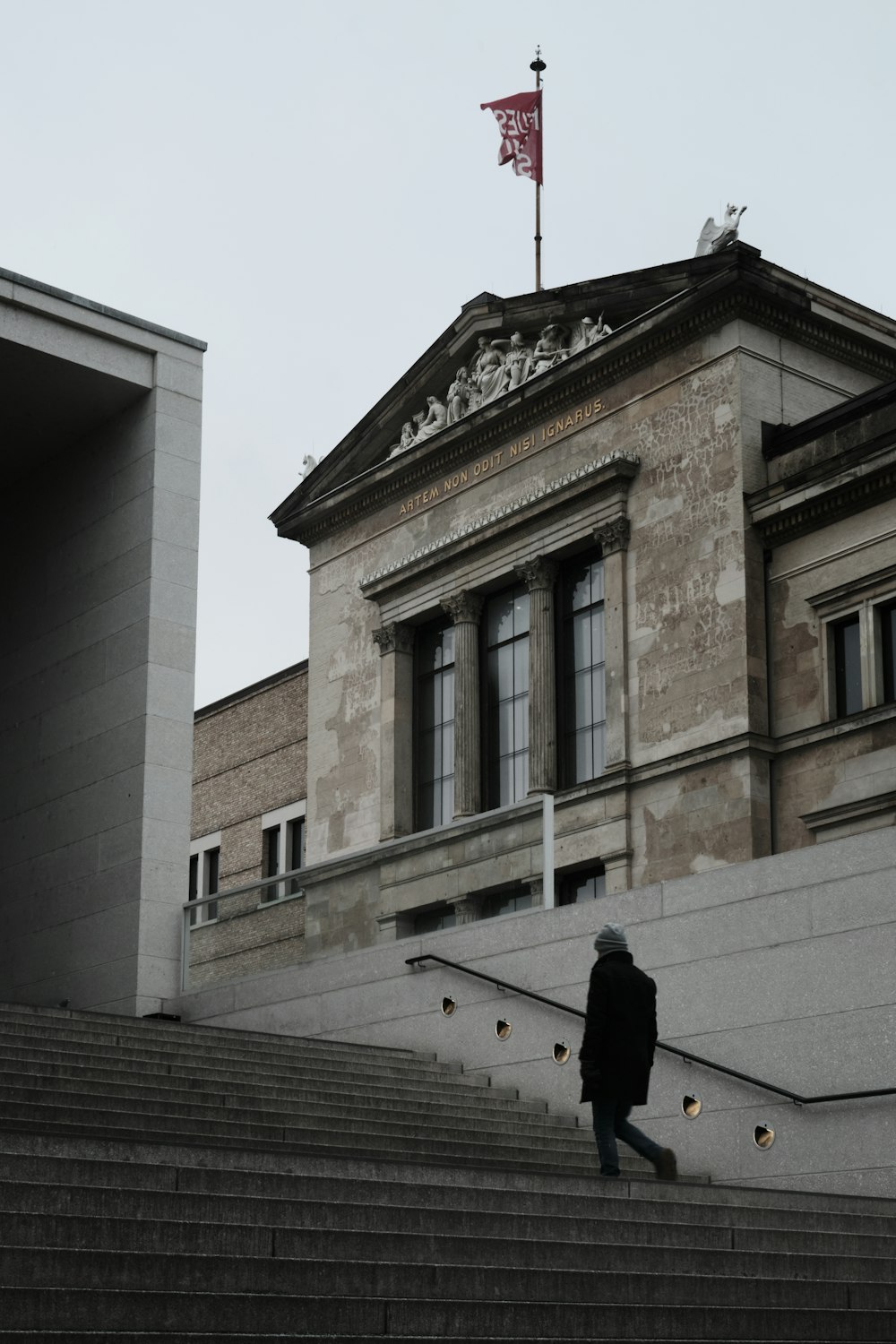 a person walking up some stairs in front of a building