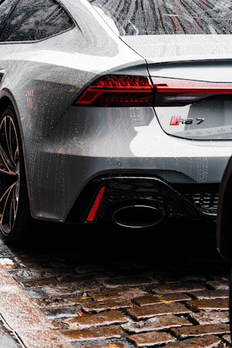 a silver sports car parked on the side of the road