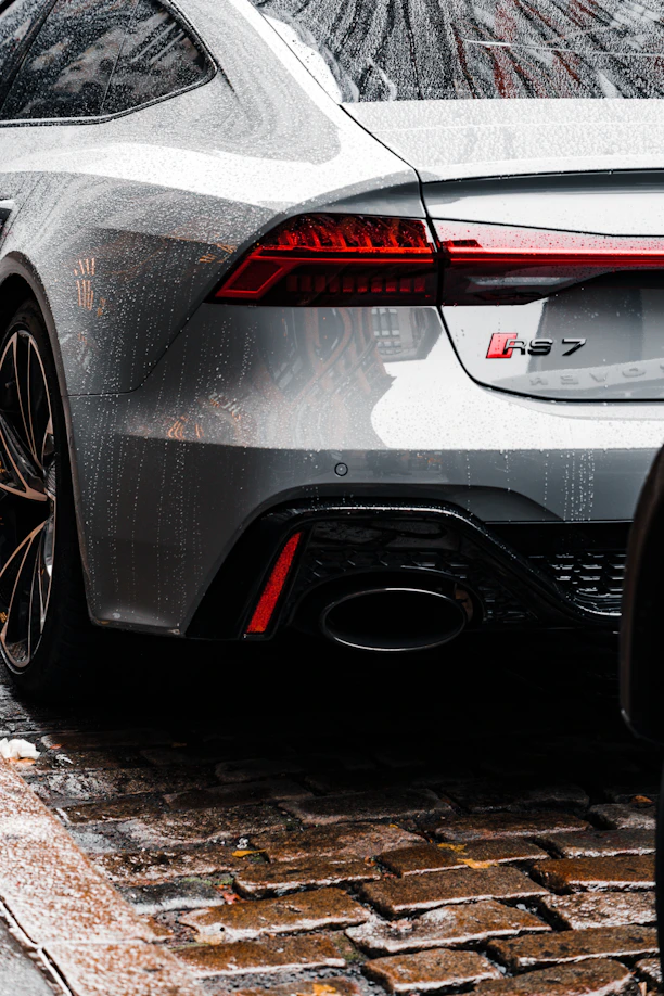 a silver sports car parked on the side of the road
