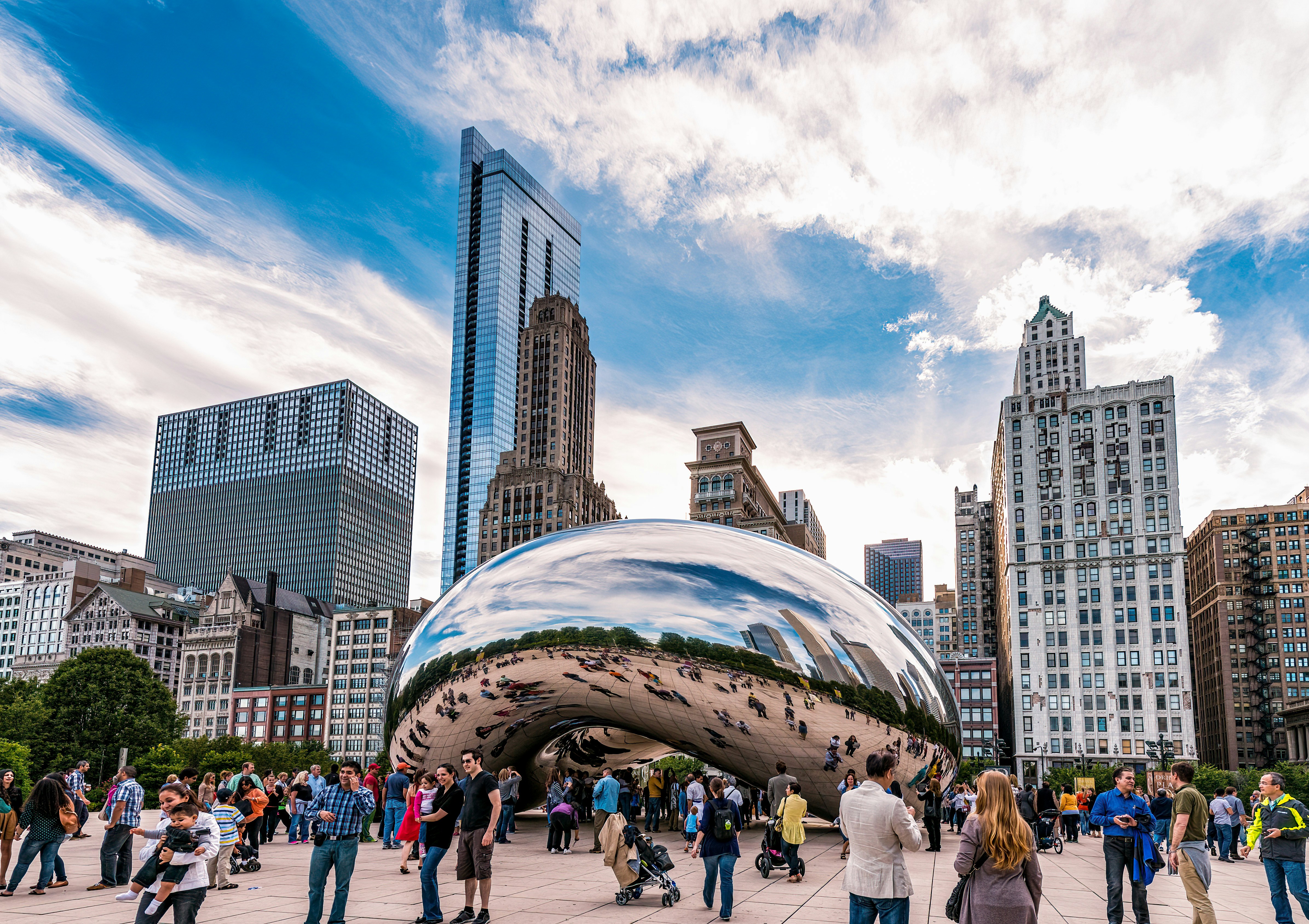A group of people standing around a large shiny object