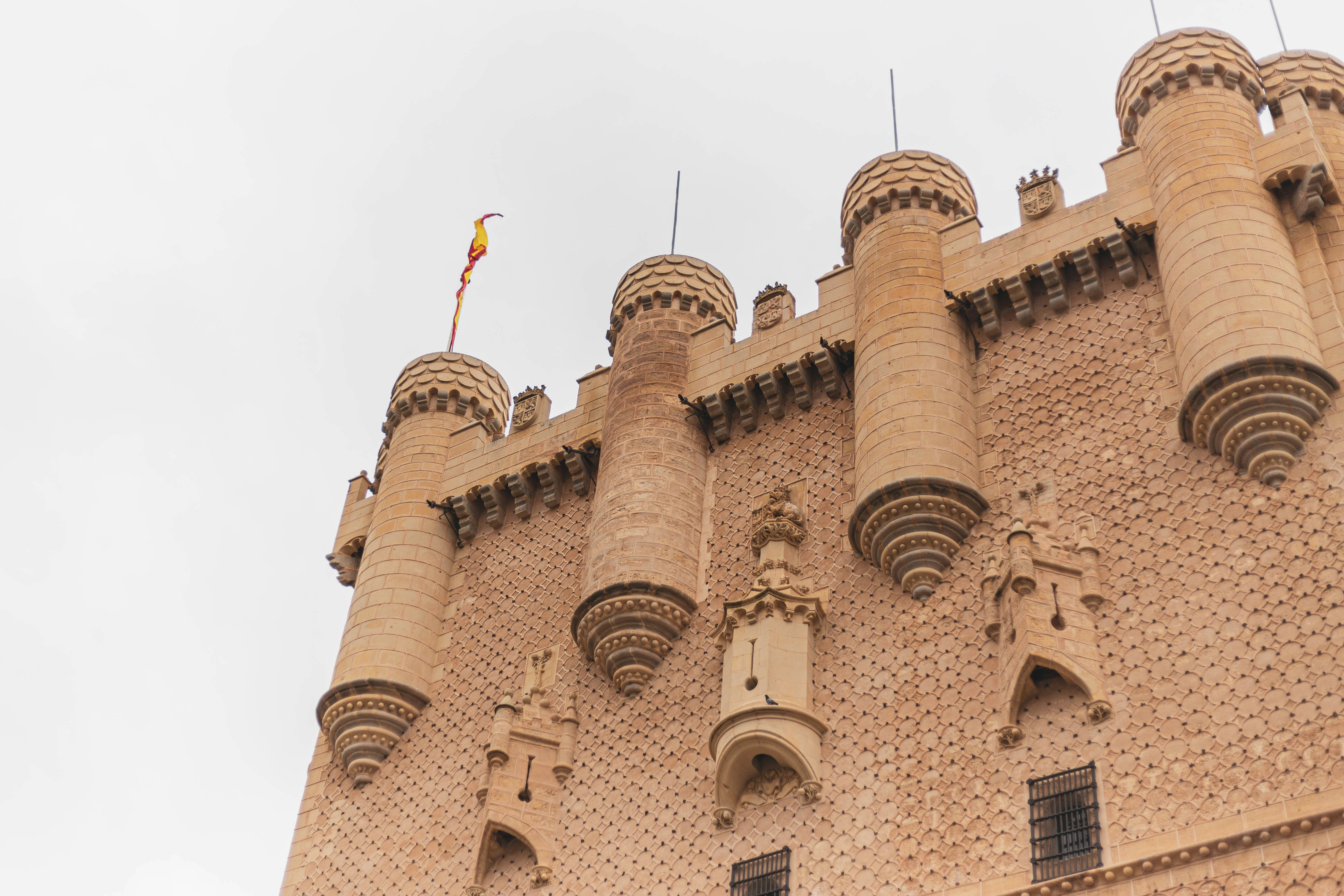 a very tall brick building with a clock on it's side