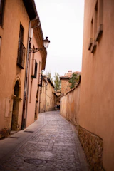 A charming guide leading a small group through the narrow streets of Cap Valéor's old town at golden hour.