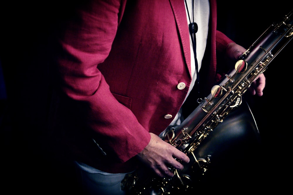 a man in a red suit holding a saxophone