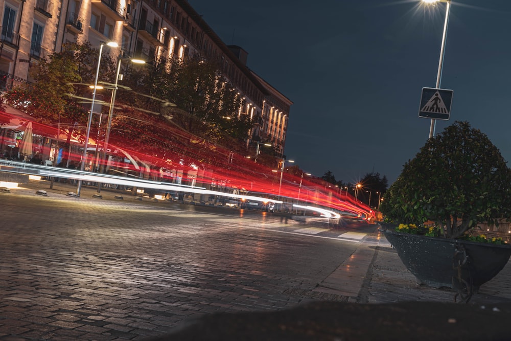 a city street at night with cars passing by