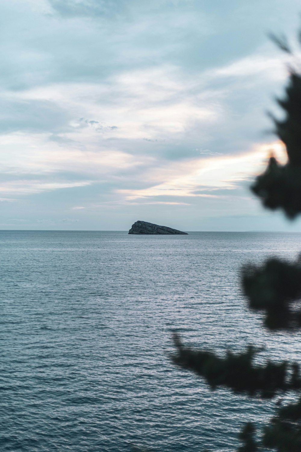 a body of water with a small island in the distance