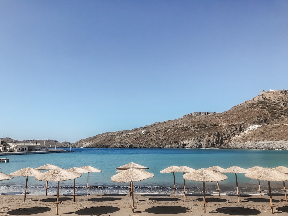 a bunch of umbrellas that are on a beach