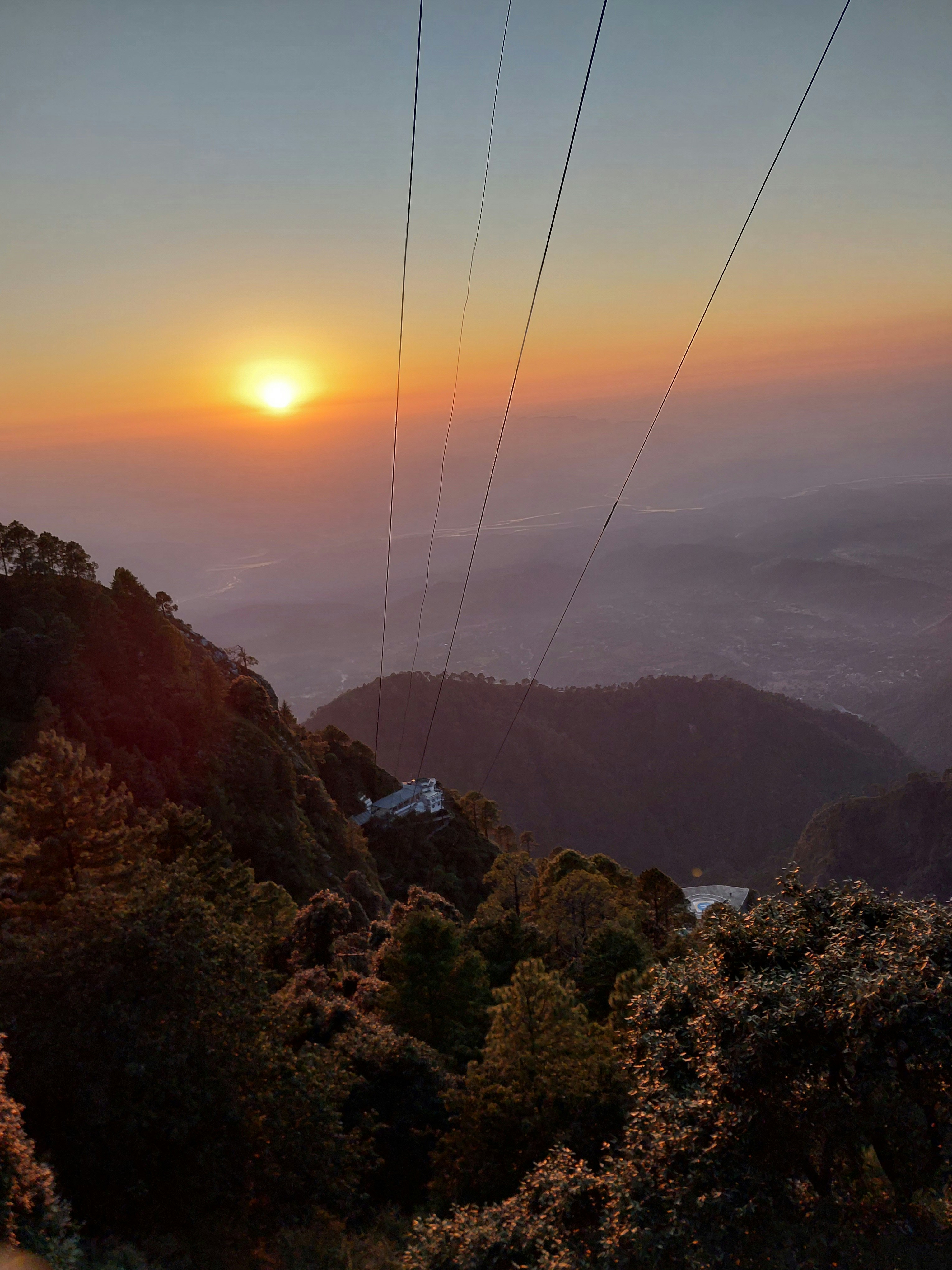 the sun is setting over a mountain range